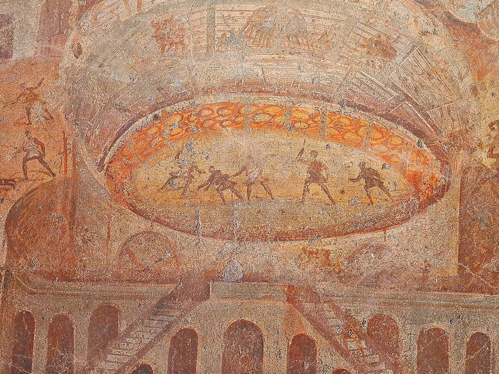 I.3.23 Pompeii. Photo taken May 2021, courtesy of Giuseppe Ciaramella. Rear wall of the peristyle.
Detail of fighting inside the amphitheatre, from painting Riot in the Amphitheatre.
Now in Naples Archaeological Museum. Inventory number 112222.