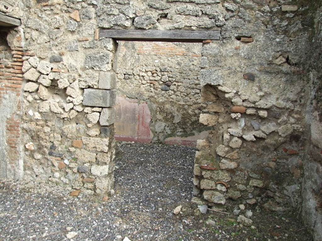 I.3.24 Pompeii. December 2006. Doorway to cubiculum on east side of peristyle.
According to Fiorelli, the wall painting of a lion, hind, dog and hare found in the corner of the walkway, was found next to this doorway. See Pappalardo, U., 2001. La Descrizione di Pompei per Giuseppe Fiorelli (1875). Napoli: Massa Editore, (p.40)
According to Bull. Inst. – “In un altro angolo del peristilio è dipinto, nella maniera grossolana delle pitture topiarie, un leone che dilania una cerva e più sotto un cane che addenta una lepre”. (translation: "Found painted in a coarse manner in another corner of the peristyle was a lion tearing apart a hind and beneath a dog biting a hare".) See BdI, 1869, p.239-240.