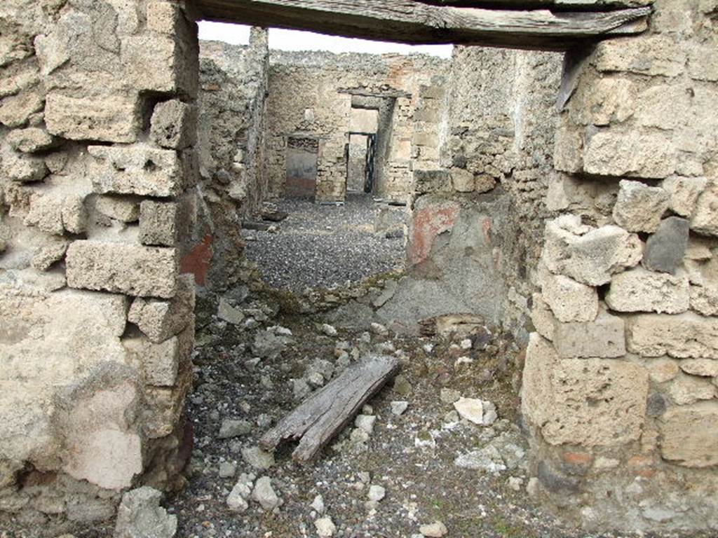 I.3.24 Pompeii. December 2006. Looking through room on north side of peristyle, across tablinum and atrium towards entrance doorway. According to Bull. Inst. – The room on the right offered some medallions painted in a fine and gracious manner. The subjects were ordinary. There was a Silenus with his crook, a mask, and a bust of Medusa. See BdI, 1869, p.239
According to Sogliano, found painted in the room on the north side of the garden were -
Head of Silenus, (nearly all vanished), p.41, no.172
Flying cupid with cornucopia, p.57, no.293
Flying cupid with alabastron on left shoulder, (destroyed), p.58, no.307
Flying cupid with his attribute vanished, p.60, no.342
Protome of Medusa, (destroyed), p.90, no.516
See Sogliano, A., 1879. Le pitture murali campane scoverte negli anni 1867-79. Napoli: Giannini.
According to Fiorelli, “On the right of this same walkway was a room, adorned with three paintings of Cupids, and by a bust of Silenus, that looked into the adjoining triclinium through a wide window”.
See Pappalardo, U., 2001. La Descrizione di Pompei per Giuseppe Fiorelli (1875). Napoli: Massa Editore, (p.40)