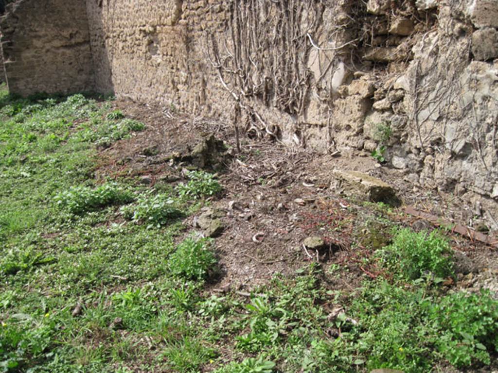 I.3.27 Pompeii. September 2010.
Looking towards remains of circular feature (base of millstone) at west end of north wall of bakery room.
Originally there would have been four millstones. Photo courtesy of Drew Baker.