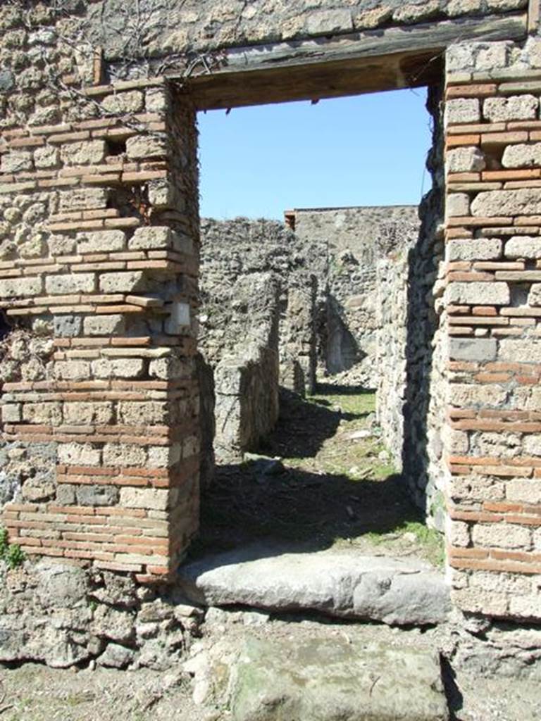 I.3.30 Pompeii. March 2009. Entrance doorway, looking north along entrance corridor.
According to Warscher, quoting Fiorelli, this was a house in the southern roadway known as Via Secunda. The entrance corridor was bordered by the kitchen, which was near a staircase, after which was the lararium painted with the Lares with rhyton and situla, now completely faded. In the storeroom a painted graffito was found –
XV K AVGVSTAS
PARTISCA ESERNIE
FVIT (CIL IV 3388)
See Warscher, T, 1935: Codex Topographicus Pompejanus, Regio I, 3: DAI, Rome.