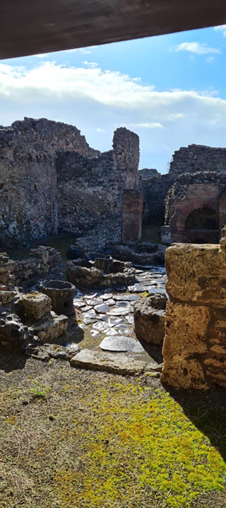 I.4.12 Pompeii. April 2022.
Looking through doorway into room b, the bakery. Photo courtesy of Giuseppe Ciaramella.