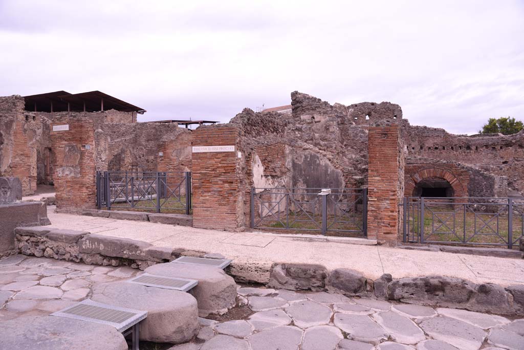 I.4.15, on left, I.4.14, in centre, and I.4.13, on right, Pompeii. October 2019. 
Looking towards east side of Via Stabiana at Holconius� crossroads.       
Foto Tobias Busen, ERC Grant 681269 D�COR.
