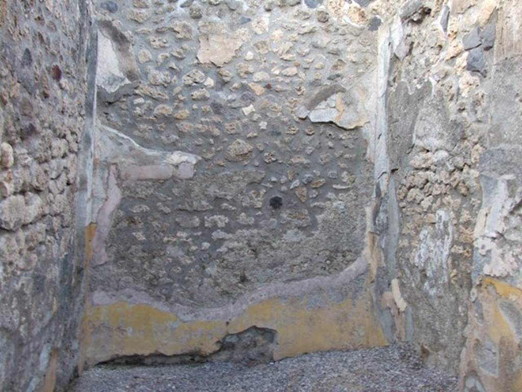 I.4.25/1.4.5 Pompeii. December 2007. Room 11, north wall of cubiculum on north side of atrium.
Remains of 1st Style decoration with a yellow zoccolo dominated by a projecting shelf of stucco (only partially conserved) under the white middle zone of the wall.