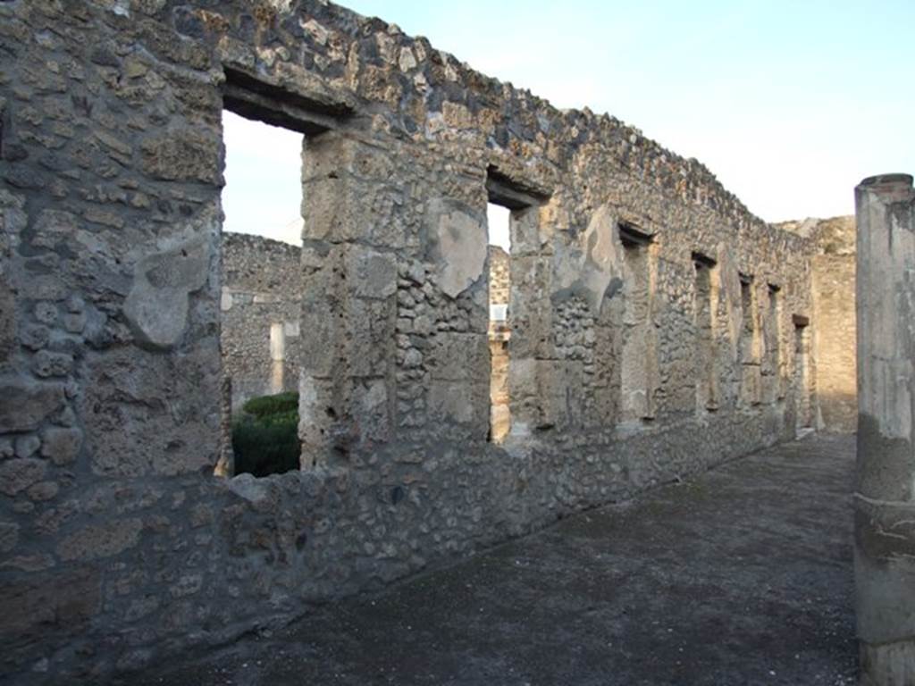 I.4.25 Pompeii. December 2007.
Looking north-east along the north wall of the lower peristyle 32, with windows to the middle peristyle 17.
Photographed from outside room 36.
