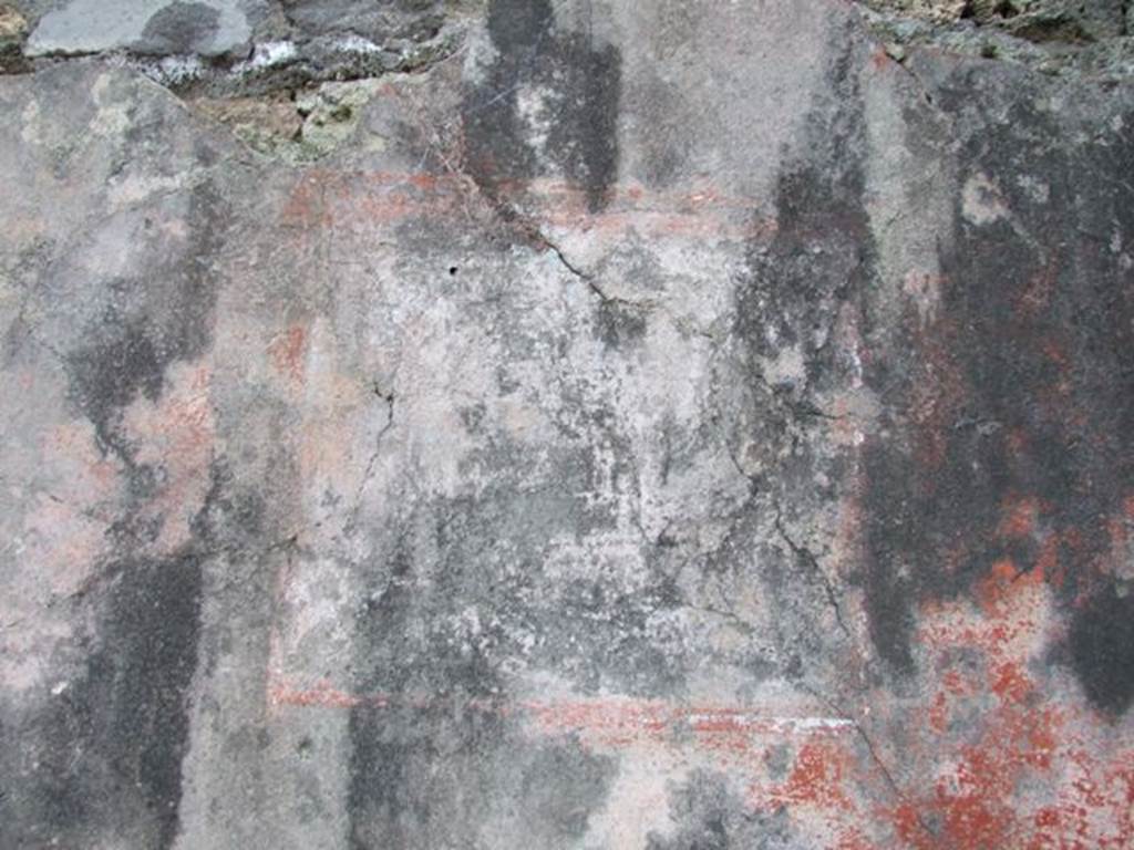 I.4.25 Pompeii. December 2007. Upper peristyle 56, remains of painted decoration on south wall in south-west corner.