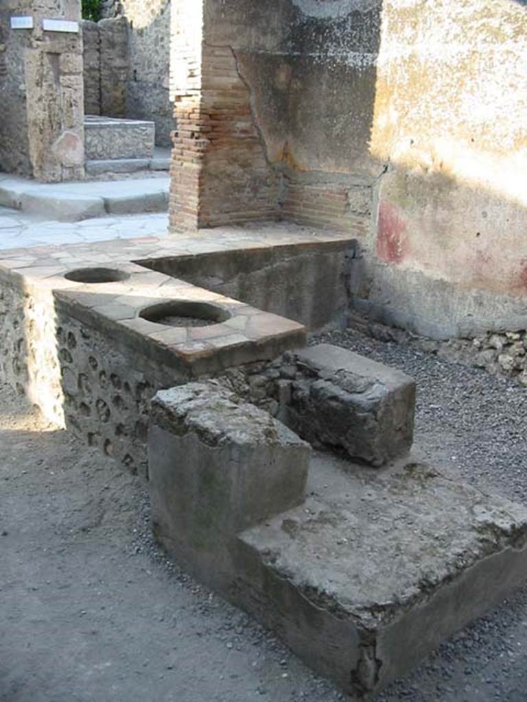 I.4.27 Pompeii. May 2003. Rear of hearth, looking to front of bar or sales-room.
Photo courtesy of Nicolas Monteix.