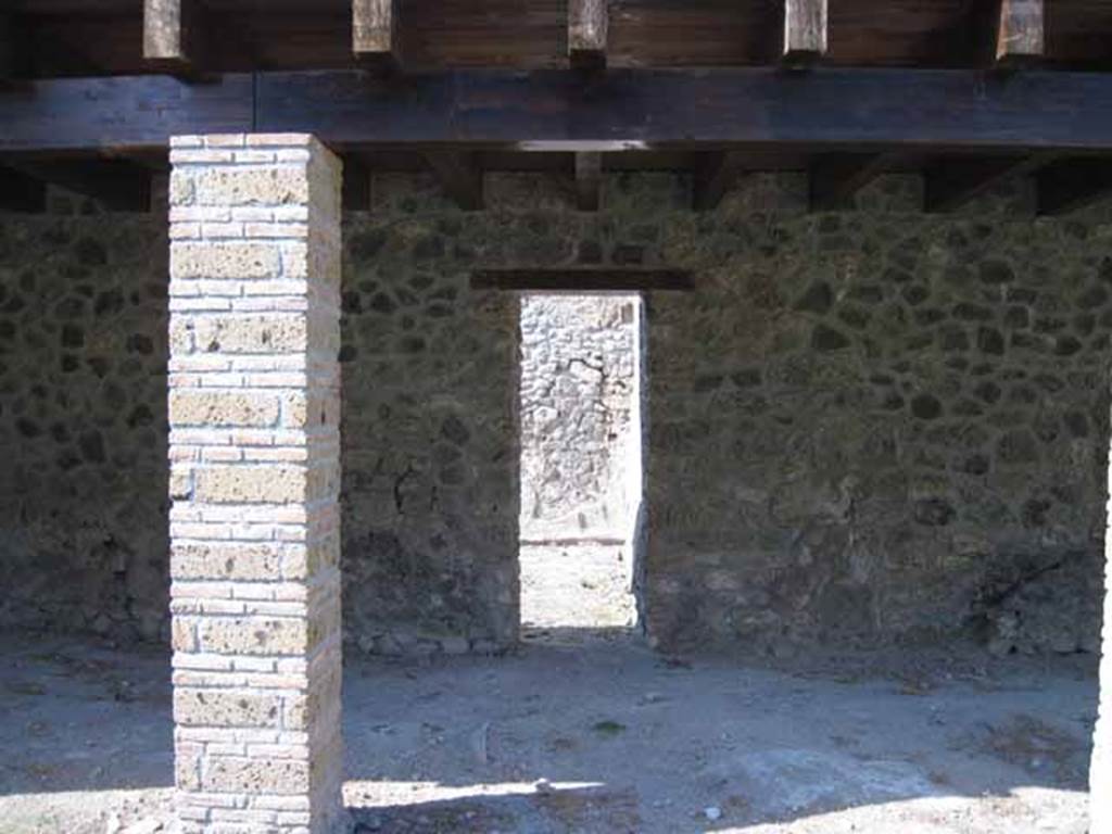 I.5.2 Pompeii. September 2010. Looking across north portico to doorway to room north of peristyle, towards the north-west corner. Photo courtesy of Drew Baker.