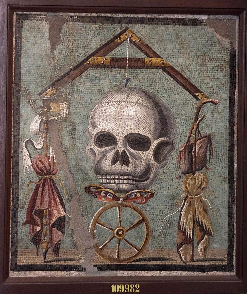 1.5.2 Pompeii. Triclinium in peristyle garden. Mosaic of a skull that formed the top of the triclinium table.
Now in Naples Archaeological Museum, inventory number 109982.