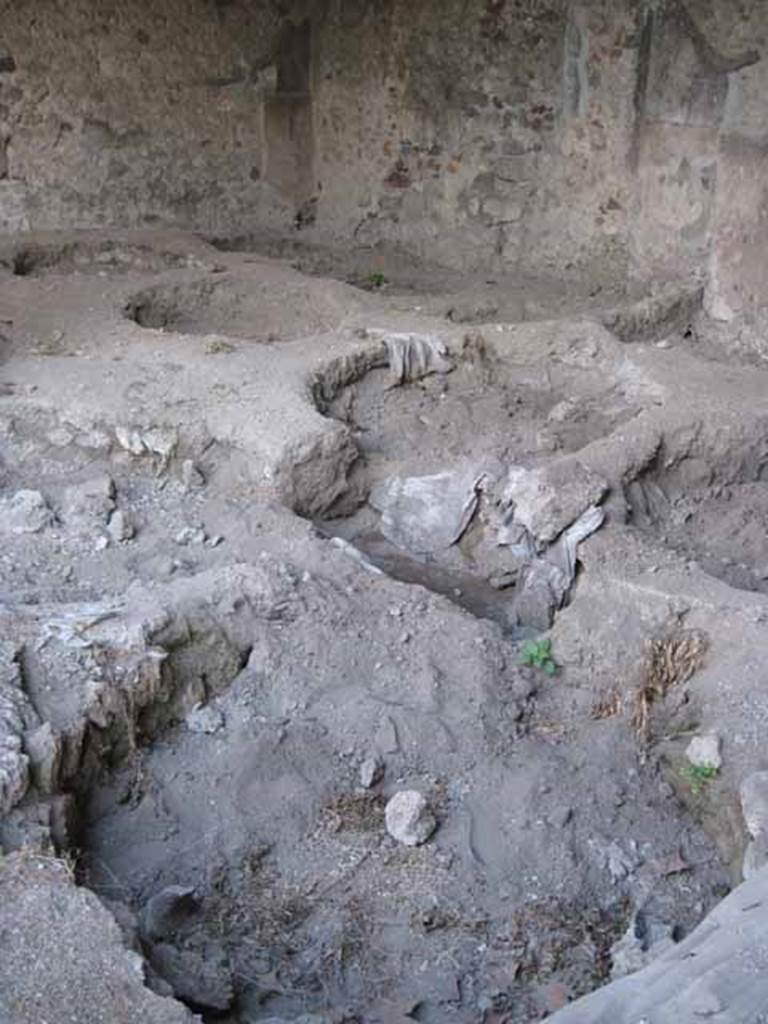 I.5.2 Pompeii. September 2010. 200 Detail of remains of round vats.
Looking towards south-east corner. Photo courtesy of Drew Baker.
According to Mau, these vats were lined with cocciopesto or crushed potsherds, and had two openings, one to add the tanning agent and the other to drain it. The vats were about 5 feet in diameter and from four to five and a half feet deep.
See Mau, A., 1907, translated by Kelsey, F. W., Pompeii: Its Life and Art. New York: Macmillan. (p. 397).