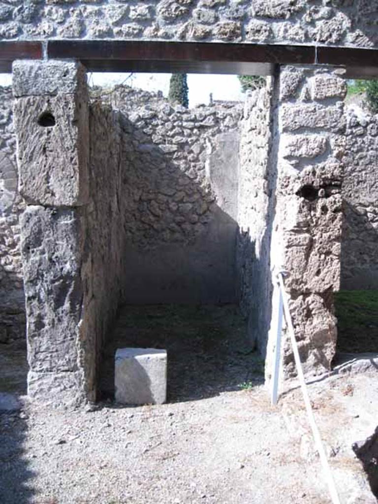 I.5.2 Pompeii. September 2010. Doorway in centre of north wall of industrial room. Note large square block of cipollino marble. The doorway on the right, leads to a room possibly used as a dormitory. Photo courtesy of Drew Baker.