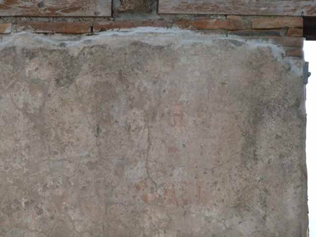 I.6.1 Pompeii. May 2010. West side of entrance. Remains of graffiti.