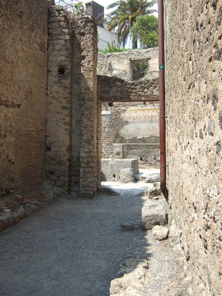 I.6.1. May 2006. Vicolo di Paquius Proculus. I.7.
Looking north past remains of water column to Shrine of 12 Gods.