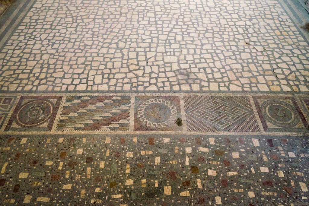 I.6.2 Pompeii. October 2023. 
Looking east across flooring from antecamera, across decorated threshold towards oecus/triclinium. Photo courtesy of Johannes Eber.
