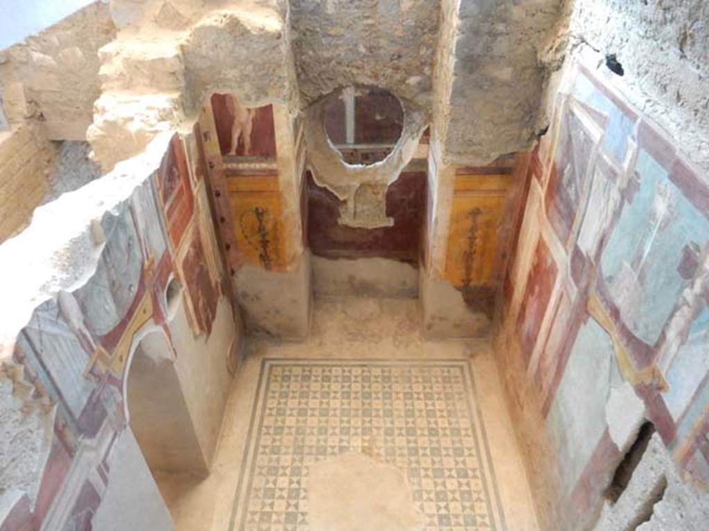 I.6.2 Pompeii. May 2016. Frigidarium of baths’ area. Looking down on west wall and circular window through into corridor in east wing of cryptoporticus. Photo courtesy of Buzz Ferebee.
