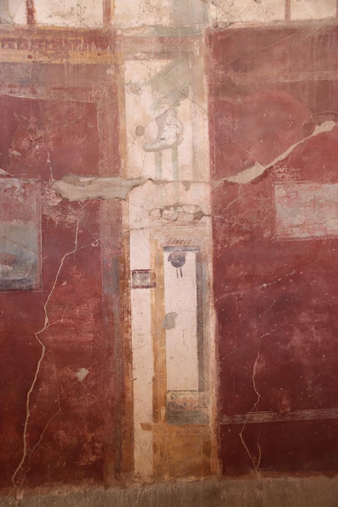 I.6.4 Pompeii. October 2024.
Room 2, west wall, detail of painted decoration on north (right) side of central painting.
Photo courtesy of Klaus Heese.
