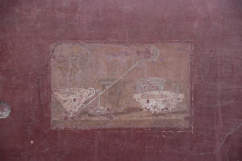 I.6.4 Pompeii. October 2024.
Room 2, wall painting of still life with silver vases from east end of north wall. Photo courtesy of Klaus Heese.