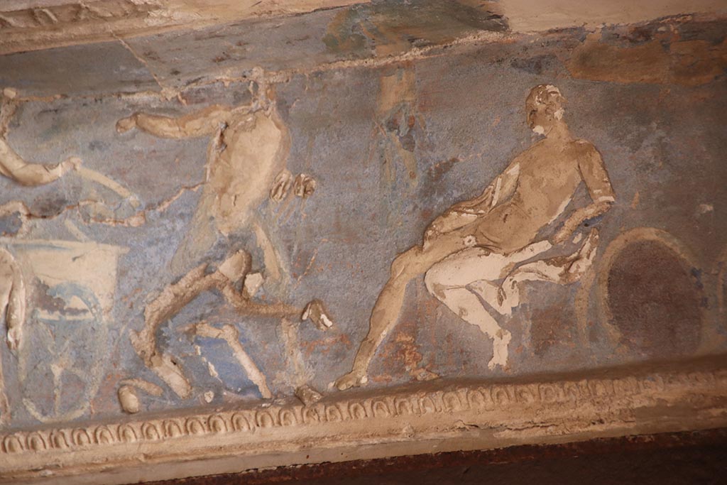 I.6.4 Pompeii. October 2024. Room 16, Priam at the feet of Achilles.
Detail from frieze on west wall towards north end of sacellum. Photo courtesy of Klaus Heese.