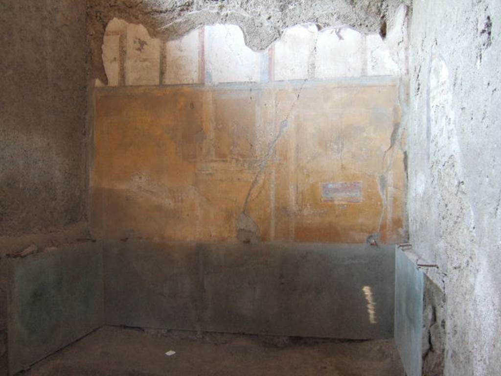I.6.4 Pompeii. December 2005. Room 17, north wall and site of impression of a bed, 2.35m long x 1.24 wide.
This is a similar photo to Fig. 510 (on page 449, and a reconstruction of the bed shown in Fig.511), described by Spinazzola as –
“Cubicolo con letto a spalliera intarsiata di riquadri in osso. Cenere con impronte delle antiche forme rassodata in sito. Impronte del telaio. Cubicolo a nord”.
(Cubiculum with backrest bed inlaid with bone panels. Impression of the ancient form hardened in the ash, in situ. Imprint of the frame. Cubiculum to the north).
See Spinazzola V., 1953. Pompei alla luce degli Scavi Nuovi di Via dell’Abbondanza (anni 1910-1923). Roma: La Libreria della Stato, (p.447, and p.449).