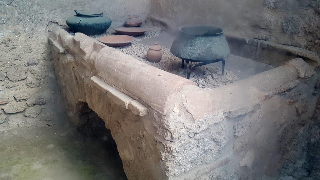 I.6.7 Pompeii. August 2023. Hearth in kitchen with household utensils. Photo courtesy of Maribel Velasco.