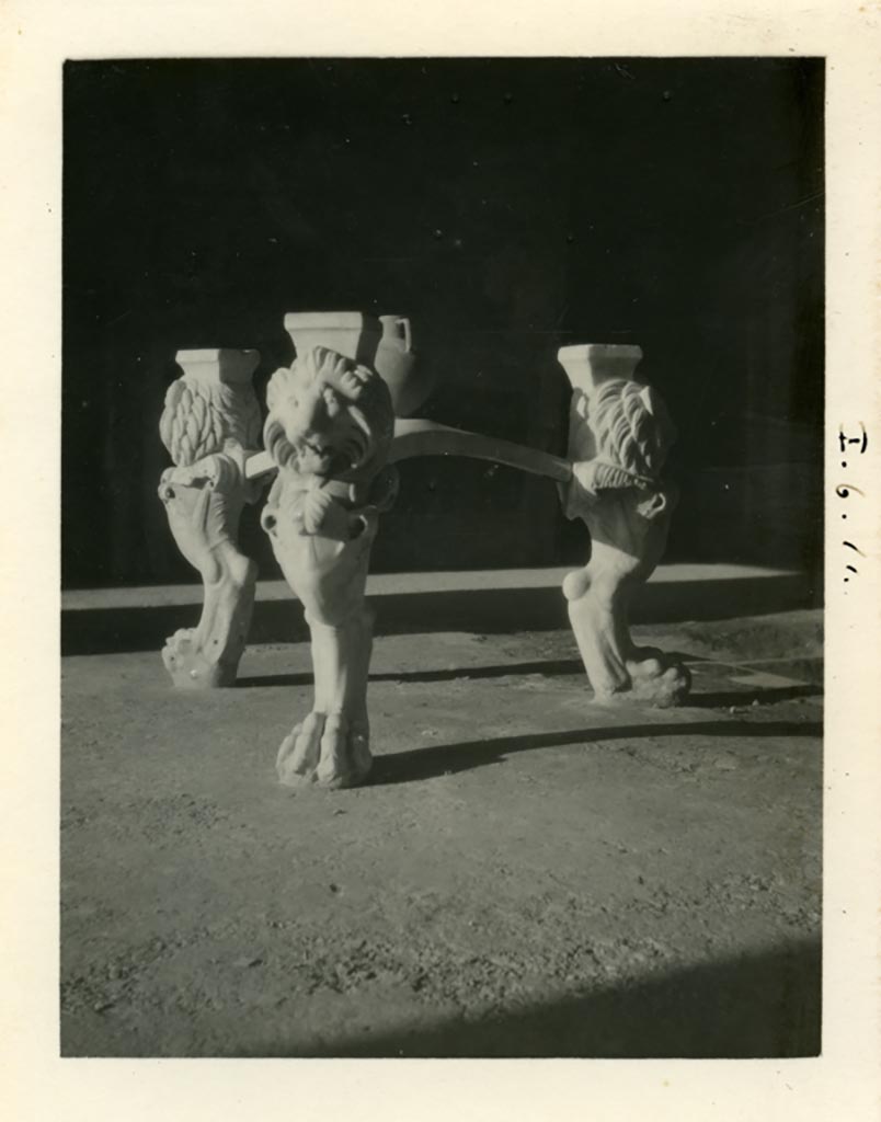 I.6.11 Pompeii. Pre-1937-39. Marble tripod table legs with lion heads and paws, in atrium.
Photo courtesy of American Academy in Rome, Photographic Archive. Warsher collection no. 1851.