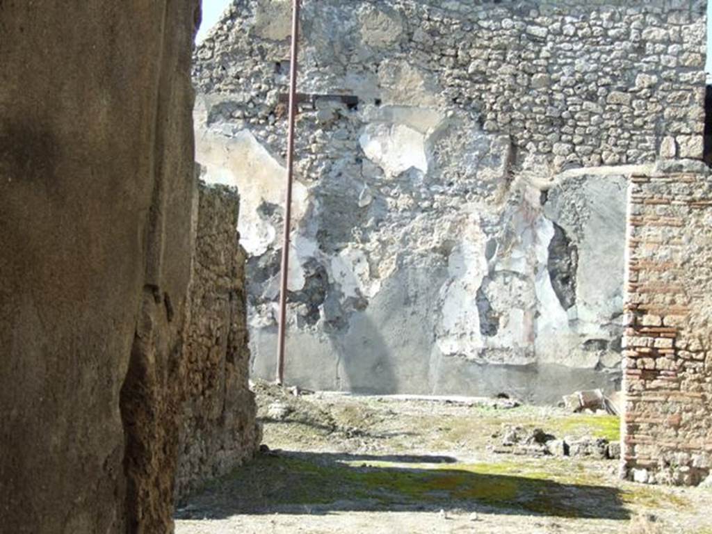 I.6.13 Pompeii. March 2009. Looking north through tablinum to remains of small garden area.
According to Jashemski –
“The small garden at the rear of the house, which was undergoing extensive repairs at the time of the eruption, was originally outlined by a low masonry wall.
There were remnants of a garden painting on the rear wall, and a lararium niche in the east wall.
See Jashemski, W. F., 1993. The Gardens of Pompeii, Volume II: Appendices. New York: Caratzas. (p.36).