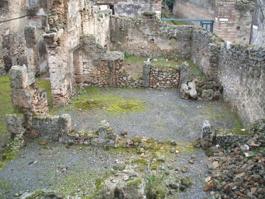 I.6.13 Pompeii. December 2004. West side looking south, photo taken from rear of I.6.11.
Triclinium 4 would appear to be the large room across the centre of the photo.
Room 7 can be seen on the lower left, room 10 on the lower right.
On the north side of room 10, (but not in the above photo) would have been a small room.
This was described on page 433 of Notizie degli Scavi, 1929, -
“as a second corridor “f” used to separate the narrow rooms 8-9-10 and corresponding to a side doorway to the western vicolo, with a wooden staircase giving access to the upper floor, a doorway that would have been closed or abolished at the time of the abandonment of the house, after the 63 earthquake.”
Room 9 would have been a small room in the north-west corner of the house.