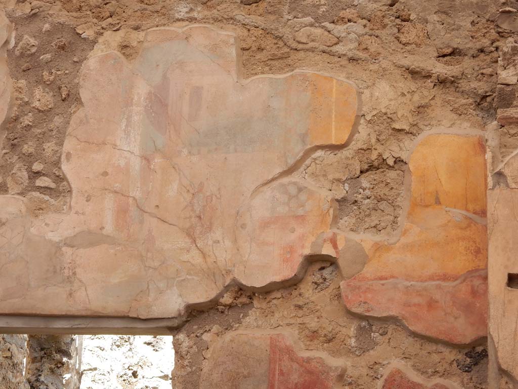 I.6.15 Pompeii. June 2019. Room 9, east wall of small garden. Detail of painting of scene with figures and temple.
Photo courtesy of Buzz Ferebee.