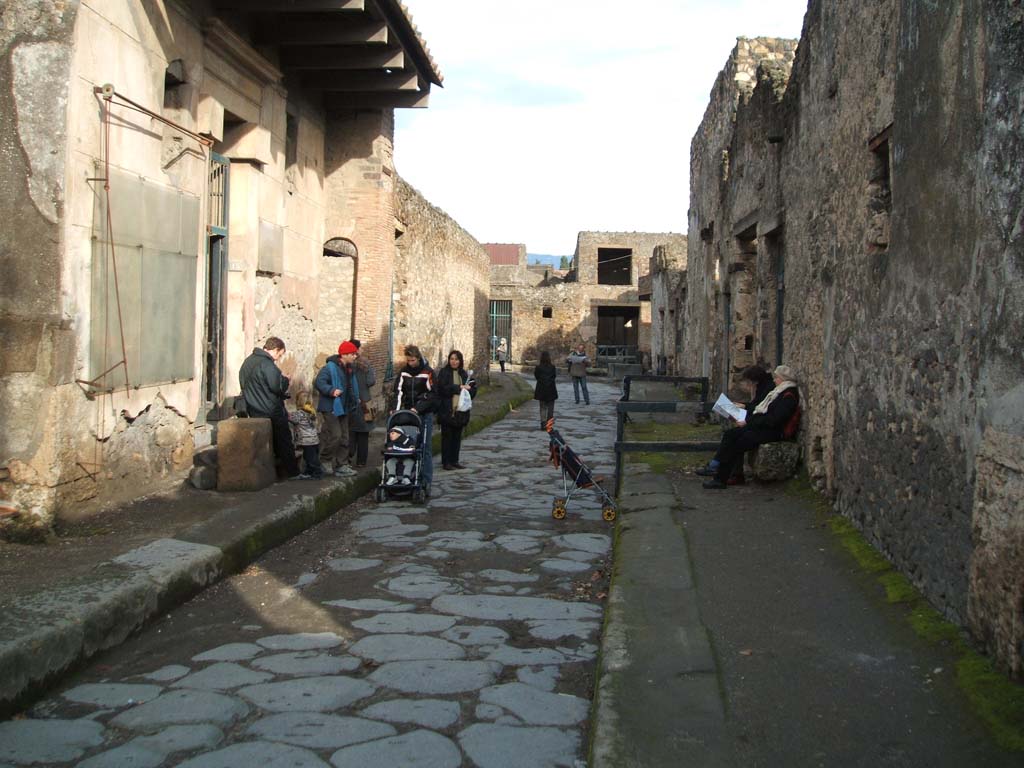 I.6.15 Pompeii, on left. December 2004. Vicolo del Menandro looking east. I.10.7 Pompeii, on right