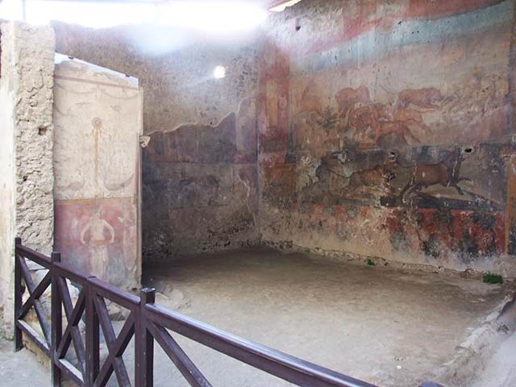 I.6.15 Pompeii. May 2009. Room 9, small arden. Looking west.
According to Jashemski –
“The small garden at the rear of the house had a portico on part of the south side.
A gutter along the east and south sides carried water to the cistern.
The best-preserved animal painting in Pompeii is on the rear wall.
Three large holes had been cut in the painting in order to install fittings for garden lights.
There is a garden painting on the lower part of the wall on each side of the animal painting.
Garden motifs also decorate the outside walls of the apotheca (store-room) in the south-west corner of the garden.
The east and west walls of the garden are each decorated with a large Egyptian landscape.
A marble dove (0.29m long) found in the kitchen may have been a garden decoration.”
See Jashemski, W. F., 1993. The Gardens of Pompeii, Volume II: Appendices. New York: Caratzas. (p.36)