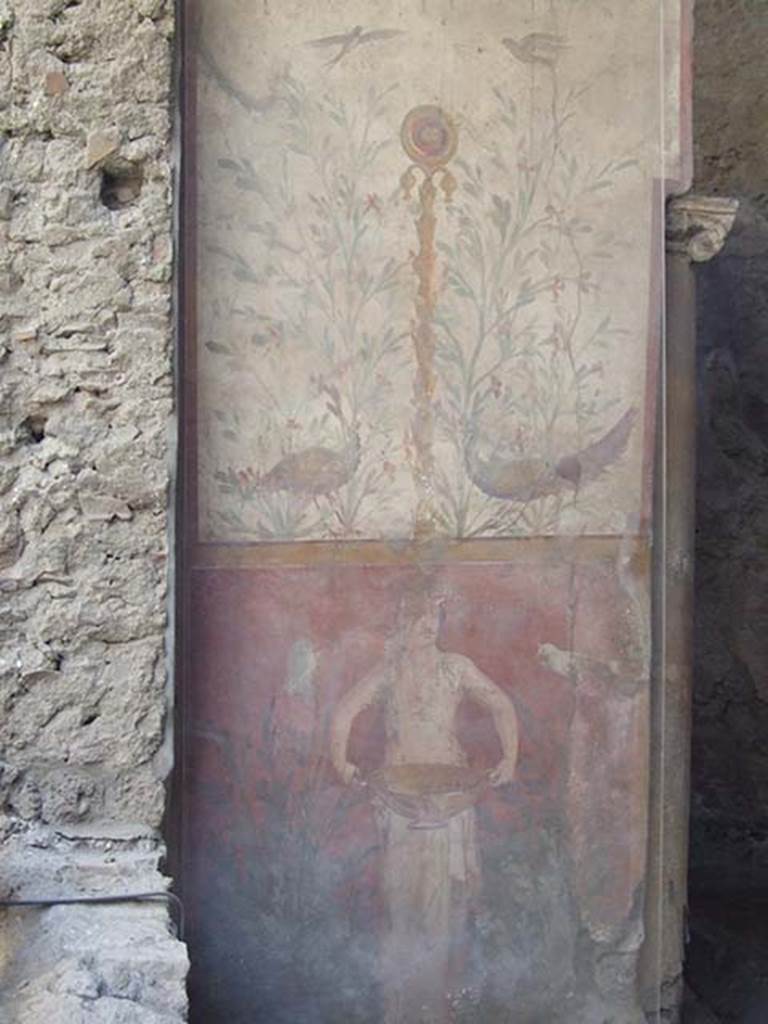 I.6.15 Pompeii. May 2009. Room 9, small garden.
Wall on west side with painting with birds, plants and a medallion above a figure holding a basin or bowl.