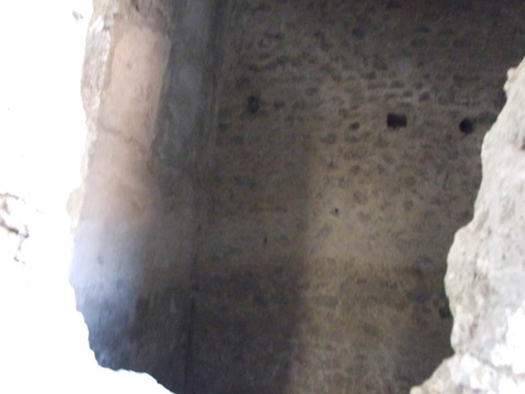 I.7.1 Pompeii. December 2007. Room on west side of fauces. Discovered in this room were the remains of a bed, on top of which were placed some pottery dishes, placed there following the eruption. Only the imprint of the wooden boards that formed the bed remained and the four iron feet which were covered in bronze. The bed would have measured 2.13 m x 1.08 m. The remains of the skeleton of a dog were recovered below the bed in the ash, searching in vain for a safe place to take refuge. See Rivista di Studi Pompeiani, I, 1987, (p.133)