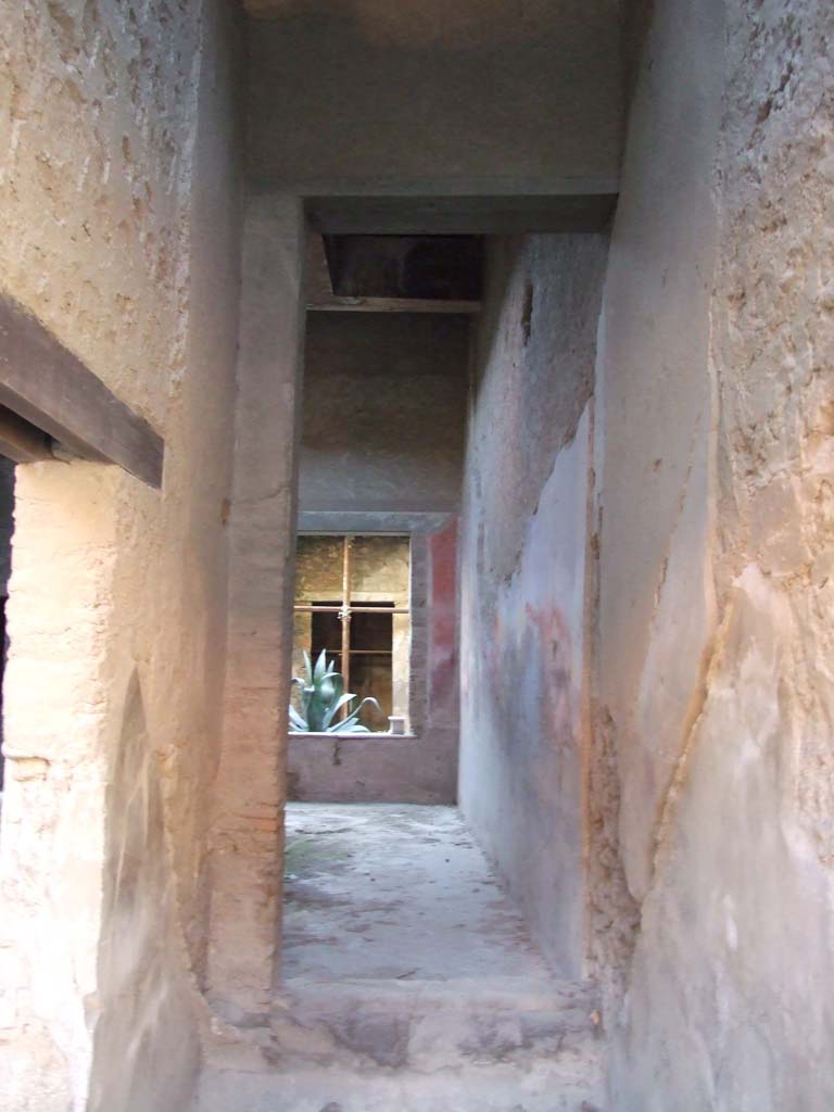 I.7.2 Pompeii. December 2007. Stairway to upper floor at front.
Looking south through site of staircase, through a room that would have been under the stairs, to atrium of I.7.3.