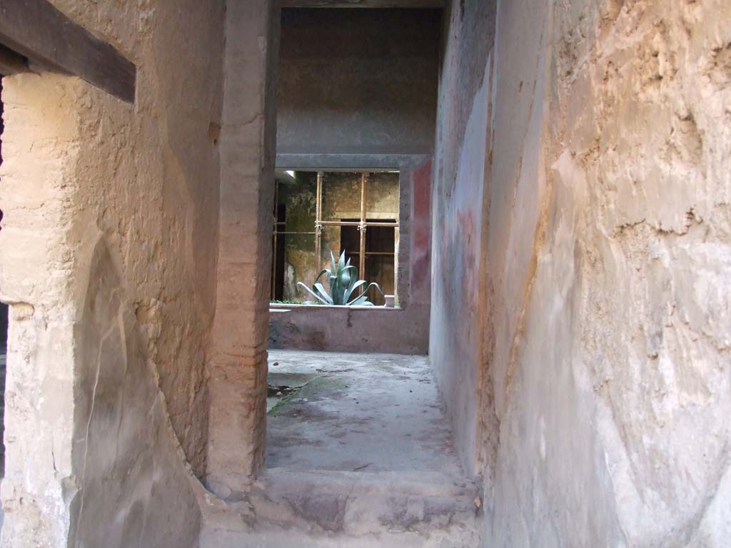I.7.2 Pompeii. December 2007. Stairway to upper floor at front.
Looking south through site of staircase, through room under the stairs to atrium of I.7.3.