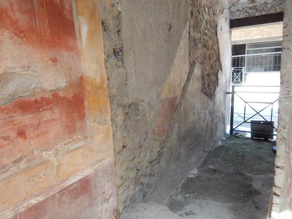 I.7.2/3 Pompeii. May 2016. Looking towards west wall through doorway in north-west corner of atrium of I.7.3, leading north to entrance at I.7.2, steps to upper floor.
Photo courtesy of Buzz Ferebee.
