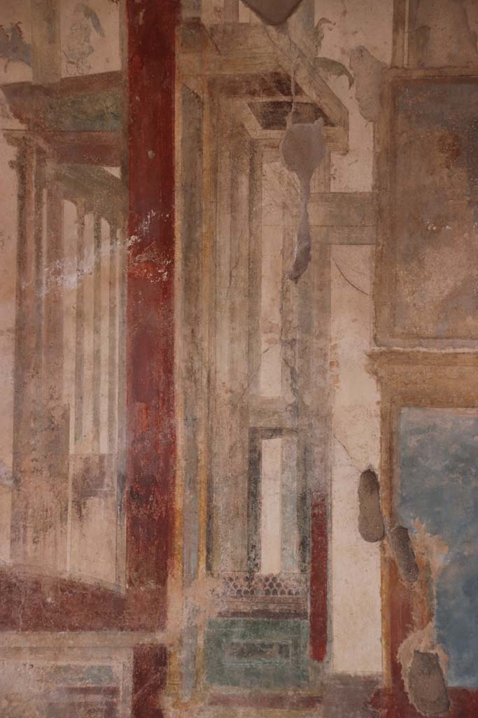 I.7.11 Pompeii. September 2021.
Detail of painted decoration on west side of central painting on north wall of triclinium. Photo courtesy of Klaus Heese.