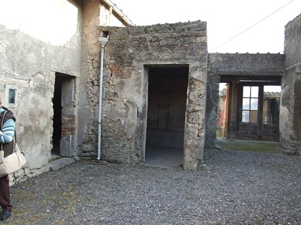 I.7.11 Pompeii. December 2006. Looking south from atrium.
On the right of the photo can be seen the area of the tablinum, leading to the north portico of the garden area. In the centre is the doorway to a cubiculum to south east of atrium. On the left is the doorway to a triclinium in the south-east corner of the atrium.