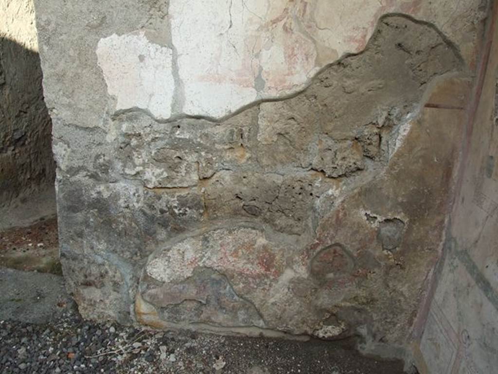 I.7.11 Pompeii. December 2006. Site of lower area of Lararium with painted serpents, not much visible today. According to Boyce, in the zone below the sacrificial scene were two red serpents confronted, one on each side of a circular altar. The altar was furnished with fruits and flowers. The serpent on the right had a red crest and beard, the head of the other was damaged. The background was filled with plants. Not. Scavi, 1927, 38 with photograph. See Boyce G. K., 1937. Corpus of the Lararia of Pompeii. Rome: MAAR 14. (p.26, no.40)