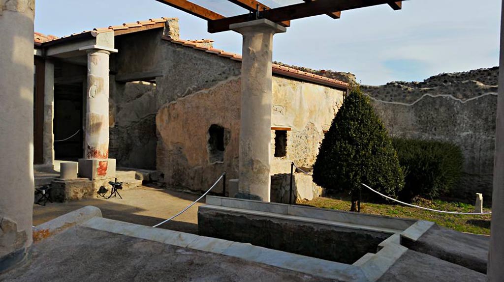 I.7.12 Pompeii. 2015/2016.
Looking north-east across triclinium in garden towards north portico and window from cubiculum, in centre. Photo courtesy of Giuseppe Ciaramella.