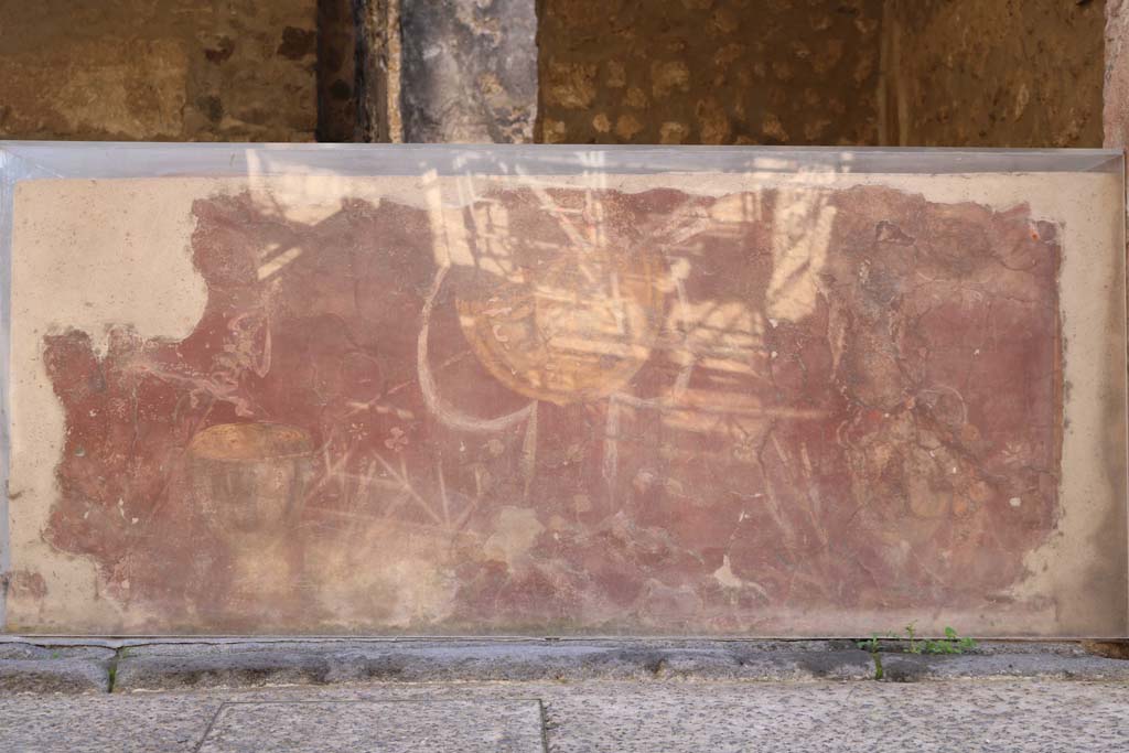 I.8.1 Pompeii. December 2018. Looking south towards shop counter. 
The shop counter shows a yellow shield or clypeus and Bacchus motifs on a red background. Photo courtesy of Aude Durand.
