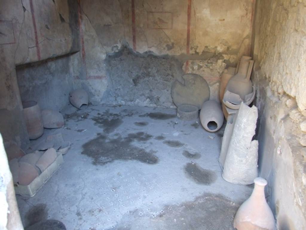 I.8.9 Pompeii. March 2009. Room 4, looking east across decorative floor in cubiculum.
According to PPM, the floor of the anteroom and alcove was in cocciopesto with pattern made by white and black tesserae. In the anteroom was a “carpet” pattern of crosses with a black centre, bordered by a row of white and black alternating tesserae, the edge of the recess was a net of diamonds edged by a a similar row of alternating black and white tesserae, and the alcove itself was of scattered white tesserae.