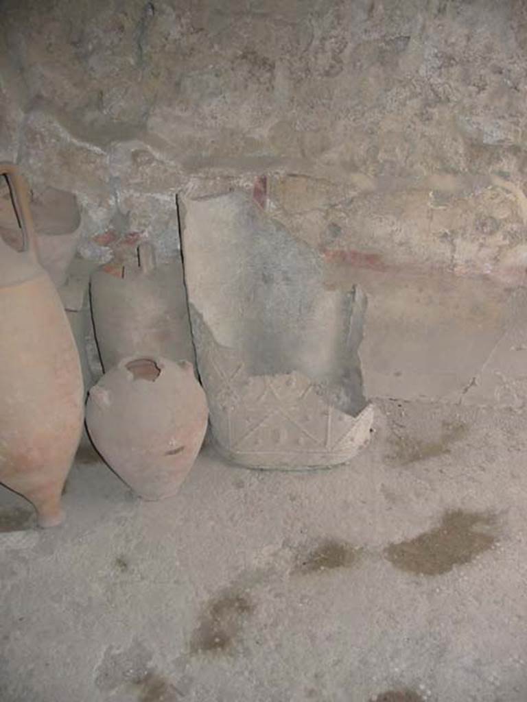 I.8.9 Pompeii. May 2003. Room 4, decorated lead bucket or puteal and terracotta items in room.
Photo courtesy of Nicolas Monteix.