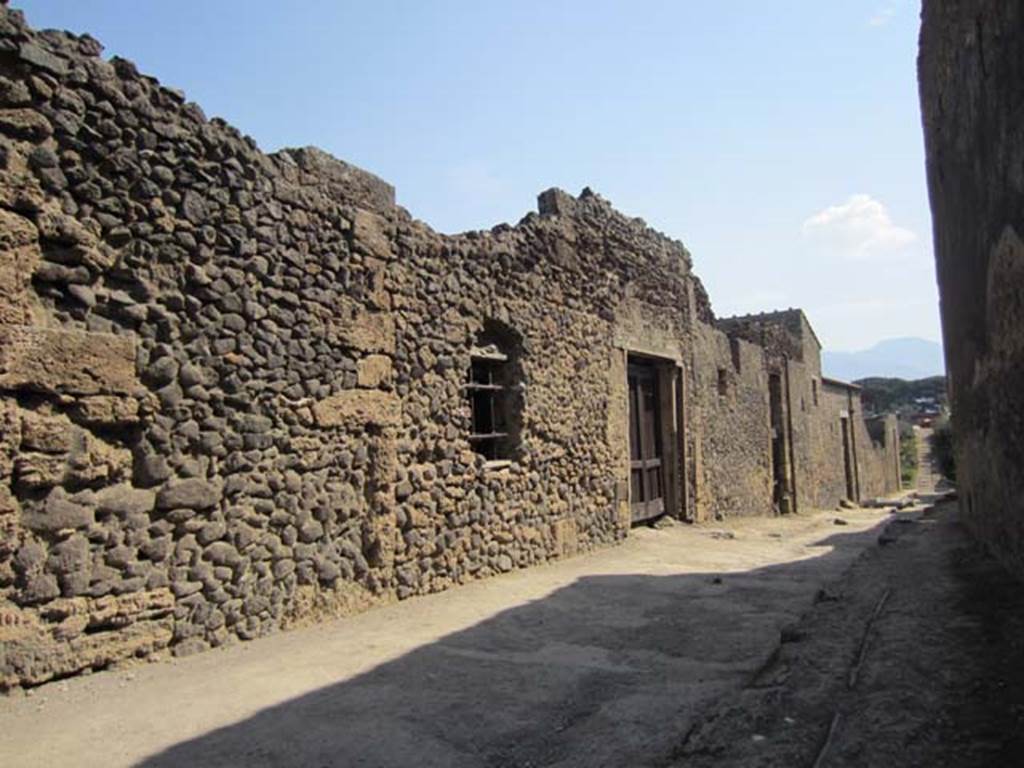 I.8.19 Pompeii. March 2012. Looking south along Vicolo dell’Efebo to window and entrance. Photo courtesy of Marina Fuxa.
