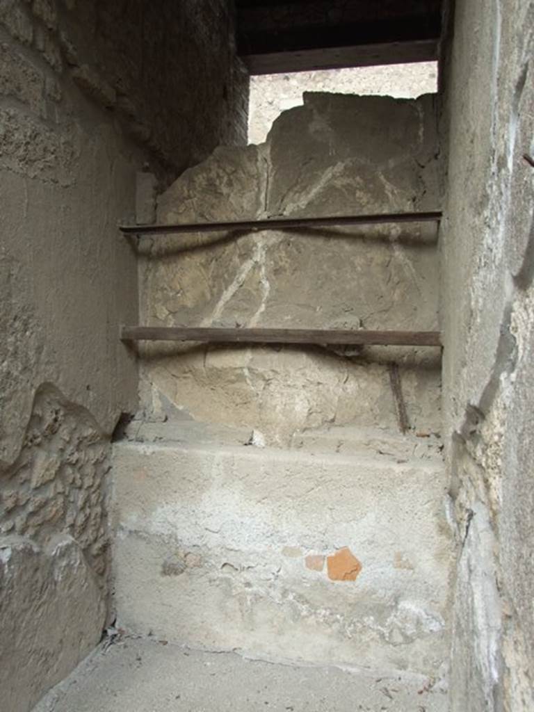 I.9.1 Pompeii. March 2009. Rear of plaster cast of entrance door in fauces.
According to PPM, the floor was of lavapesto which had a �carpet� design of white tesserae and coloured marble tiles scattered within a row of white tesserae.
