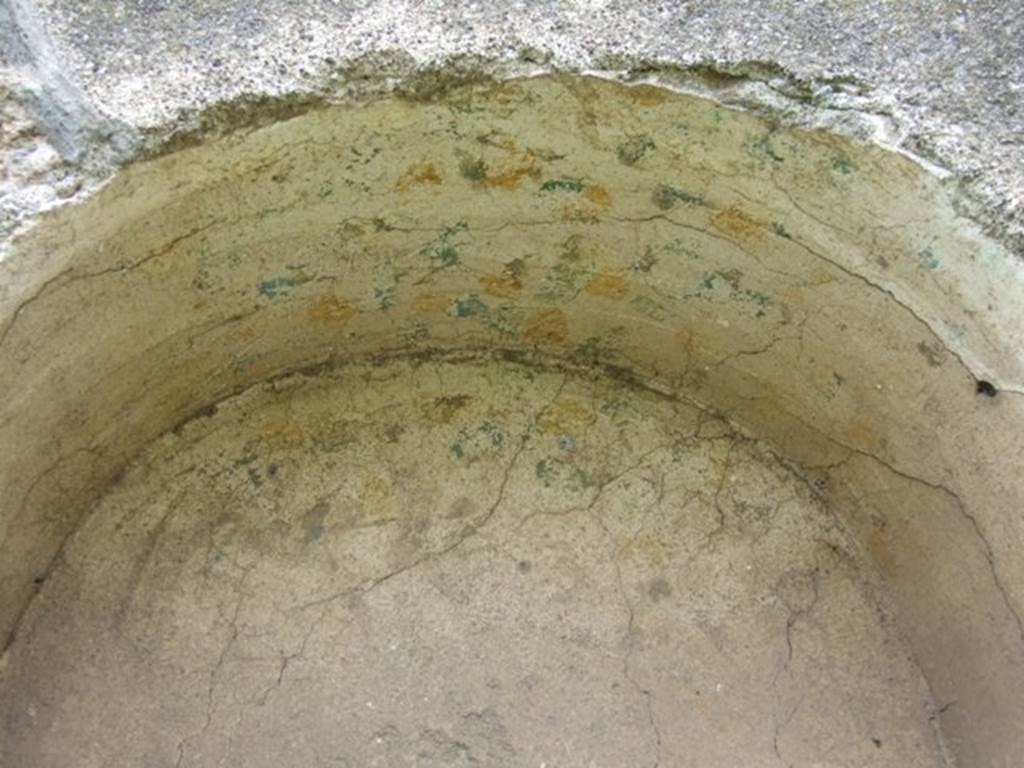 I.9.3 Pompeii. March 2009. Room 6, niche on west wall of garden area with remains of yellow and blue flower decorations.