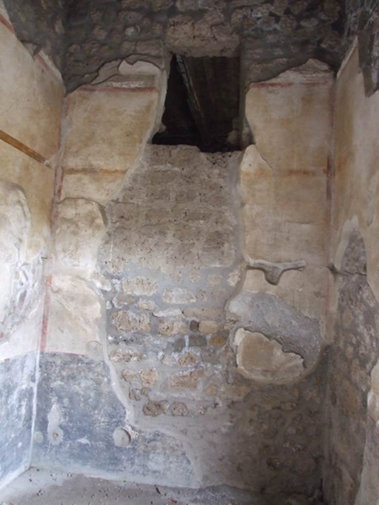 I.9.3 Pompeii. March 2009. Room 3, south wall with an ancient hole made by searchers, now filled in. The zoccolo was black, the middle area of the wall was white with a frieze of yellow, the upper part was white with a red frieze. There was an upper window. 
