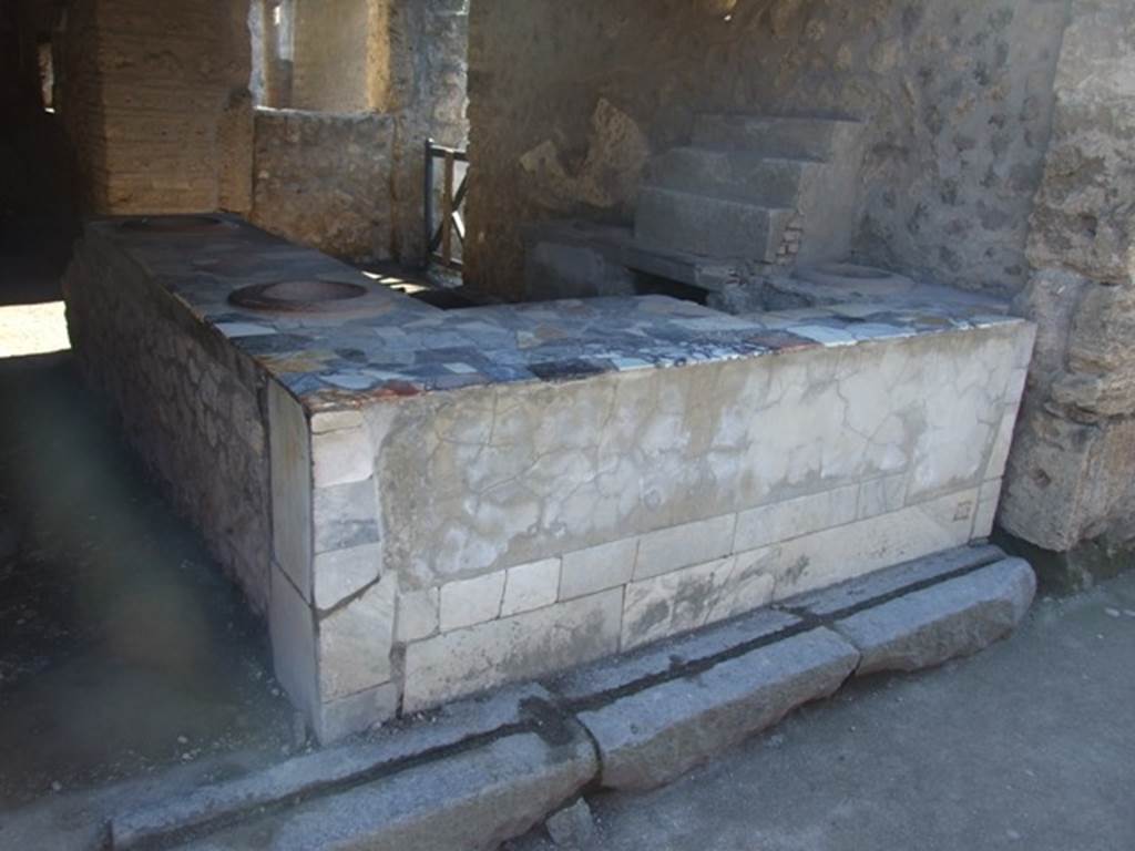 I.9.4 Pompeii. March 2009. Marble counter and display shelving.