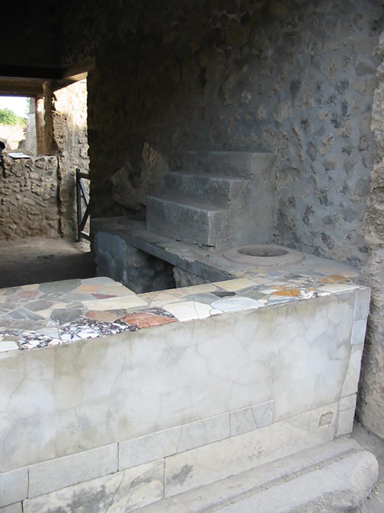 I.9.3 Pompeii. May 2003.
Counter, display shelving and entrance sill at west end. Photo courtesy of Nicolas Monteix.
