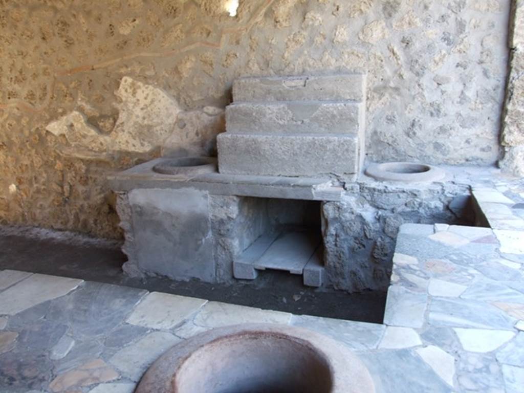 I.9.4 Pompeii. March 2009. Display shelving and two urns on west side of counter.
