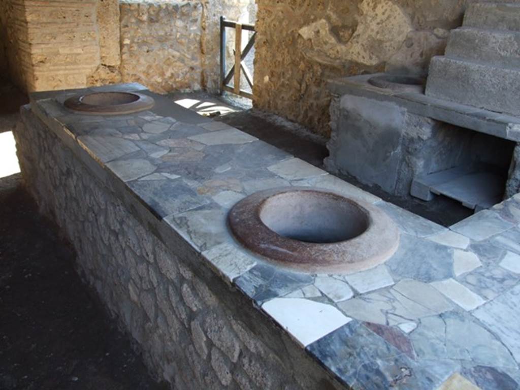 I.9.4 Pompeii. March 2009. Two urns on east side of counter.